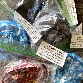 five cooling scarves each in its own ziplock bag, each with a small piece of paper stapled on saying what it is