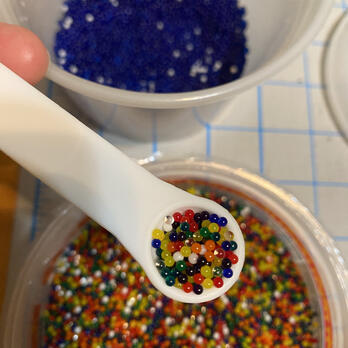 a quarter teaspoon of mult-colored water beads